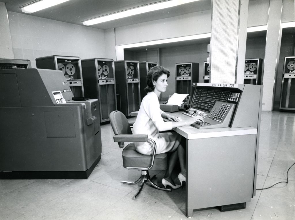 In the BNCI computer room, an operator controls an IBM 705 computer, [1957-1961], rated 11Fi747-2.